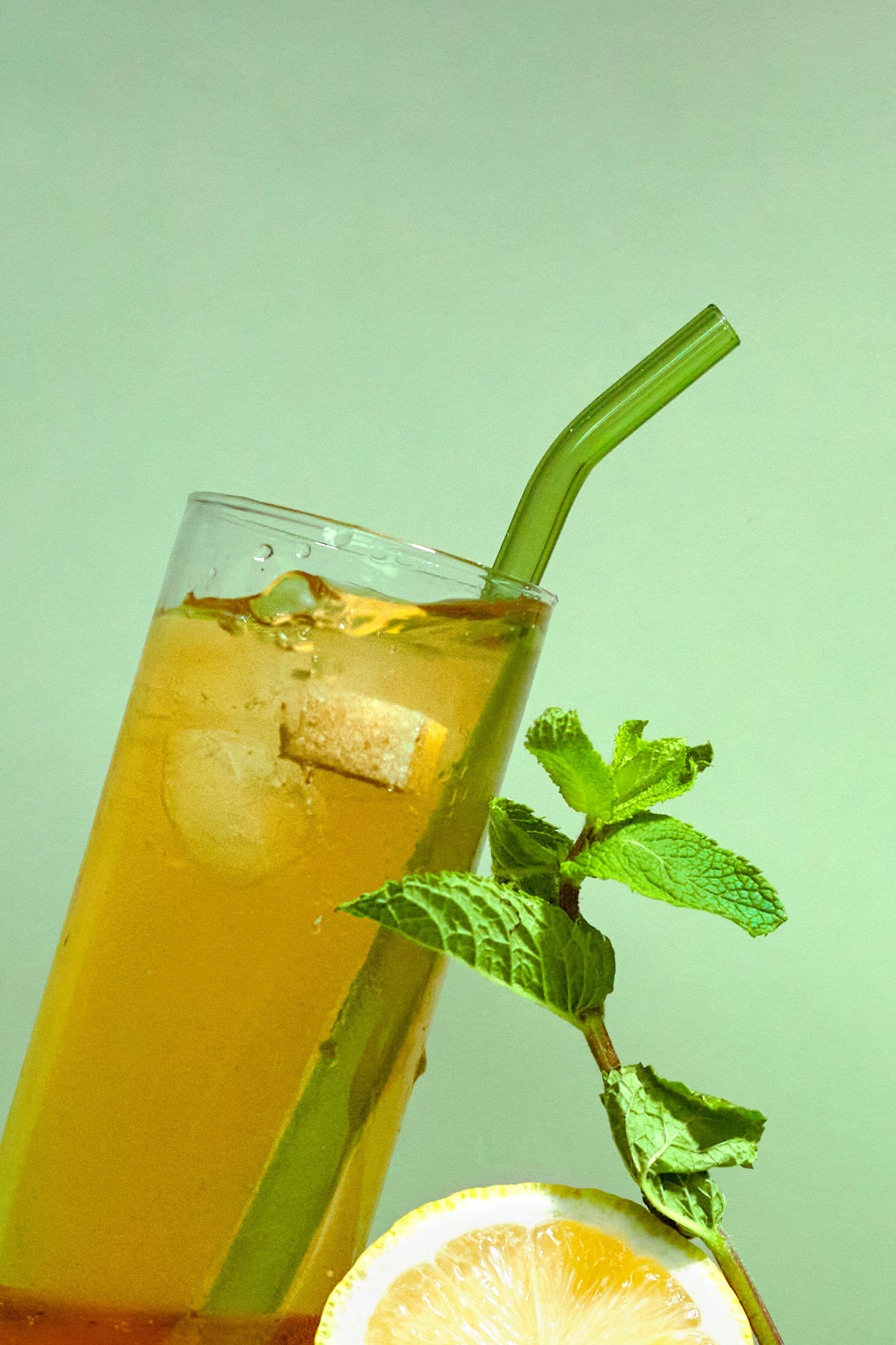 Iced Herbal Tea on Green Background